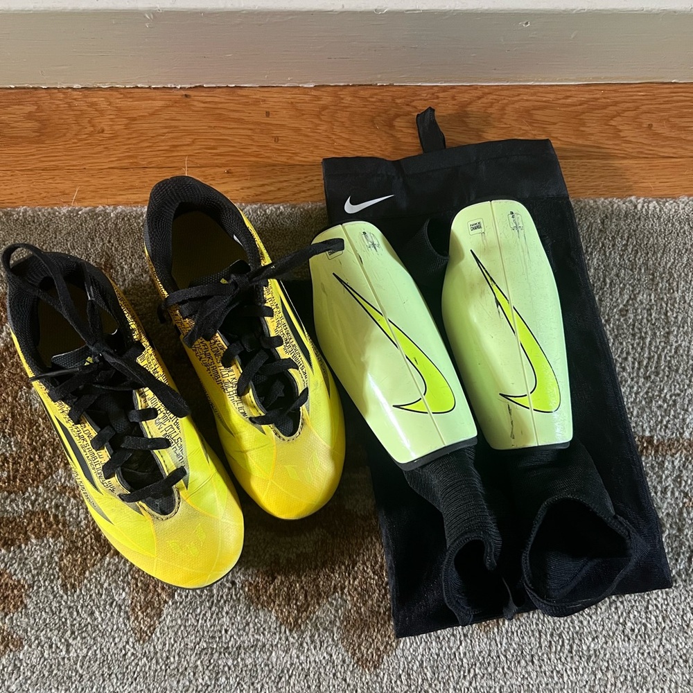 Adidas Lionel Messi Kids soccer cleats, Nike shin pads, and Nike soccer ball